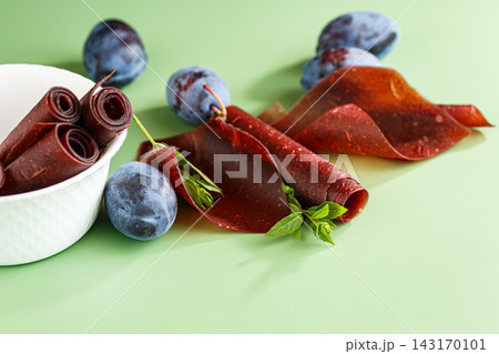 Homemade dried plum dessert with rolls on green background Homemade dried plum dessert with rolls on green background 143170101