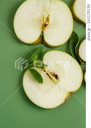 Natural apple slices with copy space on green background 143170130