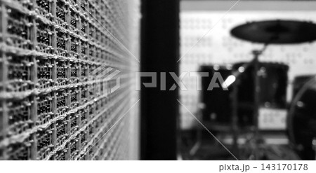 Vintage Guitar Amplifier Speaker Mesh Grill with Blurred Drum Kit in Music Studio Background Vintage Guitar Amplifier Speaker Mesh Grill with Blurred Drum Kit in Music Studio Background 143170178