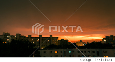 Dramatic Orange Sunset Over Residential City After Thunderstorm Dramatic Orange Sunset Over Residential City After Thunderstorm 143171584