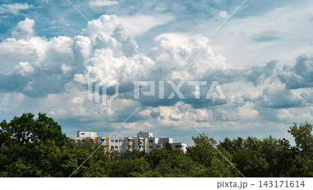 Dramatic Cumulus Clouds Above Residential Buildings and Trees Dramatic Cumulus Clouds Above Residential Buildings and Trees 143171614