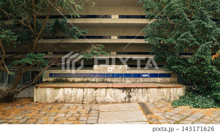 Weathered Concrete Structure with Graffiti and Urban Trees 143171626