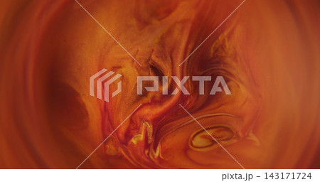 Defocused dye flow. Glitter blend. Orange golden red color sparkling paint acrylic pigment shiny round water spill on abstract art background. 143171724