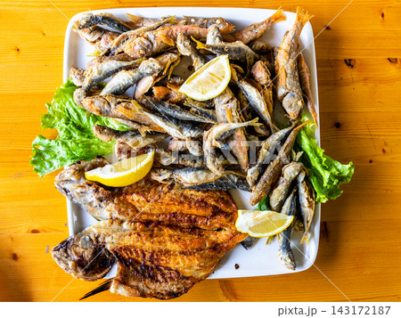 various local fried fishes on plate at wood table various local fried fishes on plate at wood table 143172187