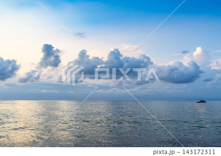 low clouds in dark blue sky over sea water at dusk low clouds in dark blue sky over sea water at dusk 143172311