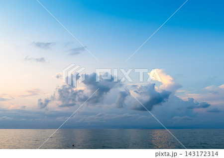 low cumuli cloud in dark blue sky in over calm sea low cumuli cloud in dark blue sky in over calm sea 143172314