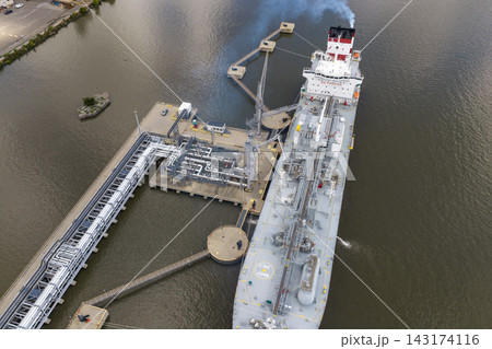 Aerial view of a large chemical tanker ship at an industrial terminal 143174116