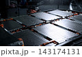 EV car service. Electric vehicle battery pack being serviced or inspected in automotive workshop. Large battery modules and high voltage components. Modern EV power systems. Lithium ion NMC NCA or LFP 143174131