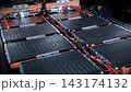 EV car service. Electric vehicle battery pack being serviced or inspected in automotive workshop. Large battery modules and high voltage components. Modern EV power systems. Lithium ion NMC NCA or LFP 143174132