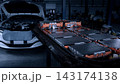 EV car service. Electric vehicle battery pack being serviced or inspected in automotive workshop. Large battery modules and high voltage components. Modern EV power systems. Lithium ion NMC NCA or LFP 143174138