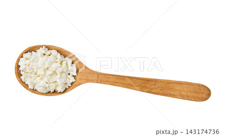 Fresh cottage cheese in a wooden spoon isolated on a white background, top view. 143174736