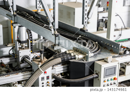Industrial cable management system with metal tray and wiring on a factory production machine Industrial cable management system with metal tray and wiring on a factory production machine 143174981