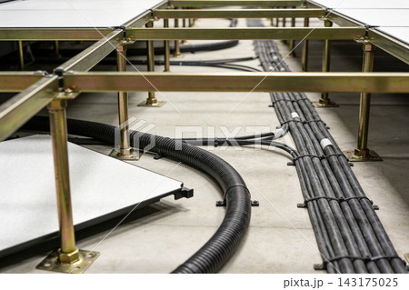 Raised access floor structure with organized electrical cabling in a modern server room facility Raised access floor structure with organized electrical cabling in a modern server room facility 143175025