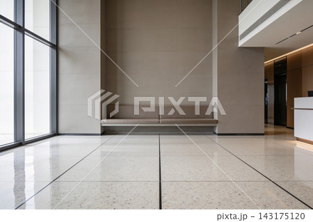 Modern minimalist office lobby interior with a long bench and polished terrazzo floor tiles 143175120