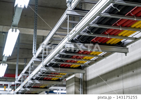 Industrial cable management system with colorful electrical wires in a modern concrete facility Industrial cable management system with colorful electrical wires in a modern concrete facility 143175255