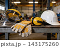 Essential industrial safety equipment displayed on a metal workbench in a professional workshop 143175260
