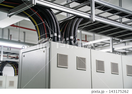 Industrial electrical control cabinet with organized heavy duty power cables in a facility 143175262
