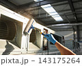 Professional technician cleaning industrial ventilation system with a specialized sponge tool 143175264