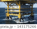 Offshore oil and gas platform structure standing in the middle of the deep blue ocean waters 143175266