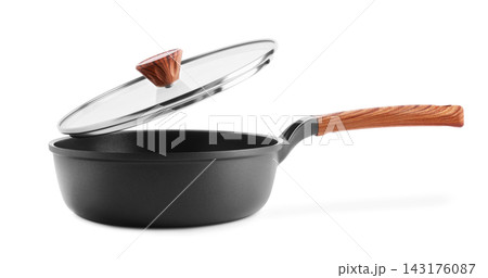 non-stick frying pan with a glass lid and wooden handle isolated on white, essential kitchenware for cooking, frying, and culinary food preparation in daily home kitchen routine. 143176087