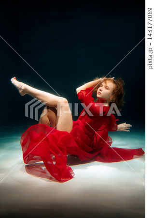 Serene underwater scene showcasing dancer in vibrant costume 143177089