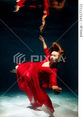 Surreal illustration of woman with flowing clothes beneath surface Surreal illustration of woman with flowing clothes beneath surface 143177112