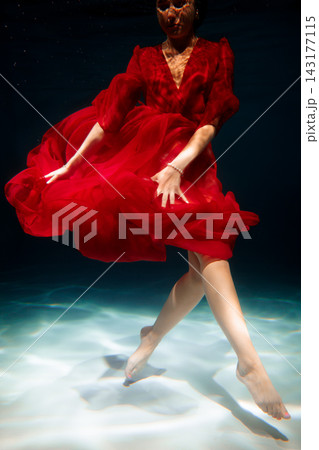 Underwater ballet artist displaying poise and vibrant movement Underwater ballet artist displaying poise and vibrant movement 143177115