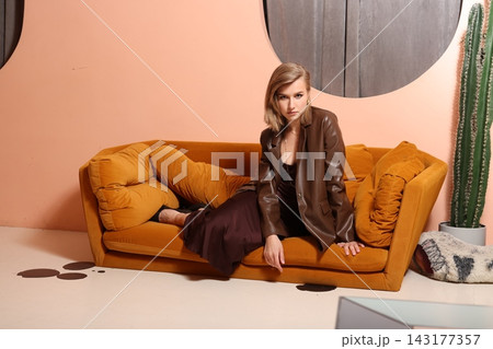 Sophisticated woman resting on warm decorative setting with accessories Sophisticated woman resting on warm decorative setting with accessories 143177357
