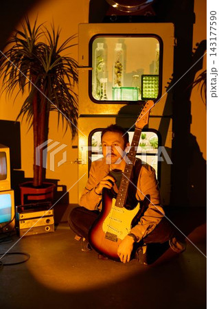 Creative artist writes song with microphone and guitar at night 143177590