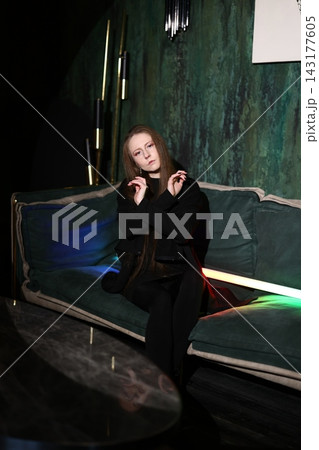Caucasian woman on sofa exuding contemporary glamour and confidence Caucasian woman on sofa exuding contemporary glamour and confidence 143177605