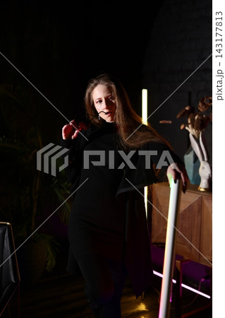 Stage performer rehearses with intense focus and subdued illumination Stage performer rehearses with intense focus and subdued illumination 143177813
