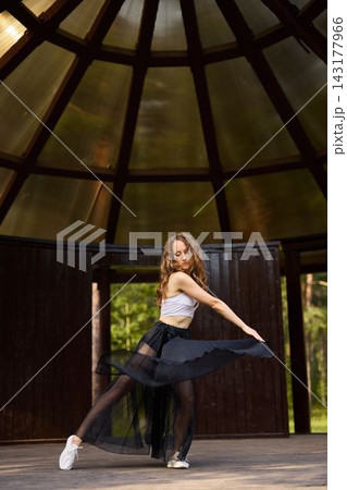Caucasian dancer practicing mindful movement for wellness 143177966