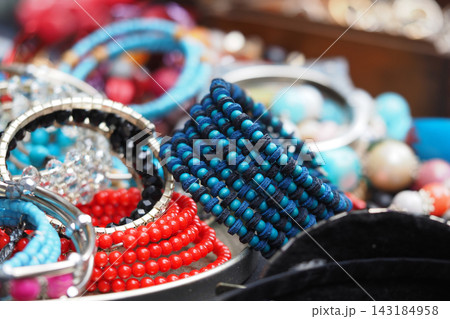 Colorful variety of bracelets displayed in a market setting Colorful variety of bracelets displayed in a market setting 143184958