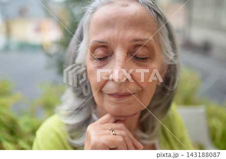 Close up of relaxed senior woman with closed eyes. 143188087