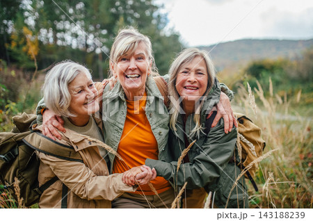 Group of mature female friends enjoying countryside walk. 143188239
