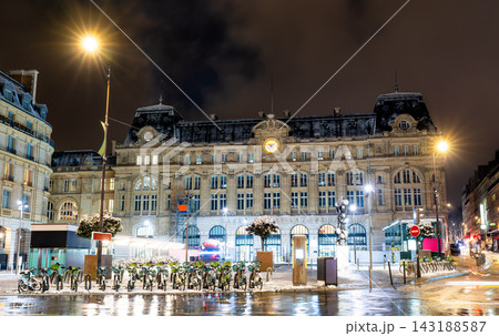 Facade of the historic Gare Saint-Lazare railway station illuminated at night with snow on the square in Paris, France. Facade of the historic Gare Saint-Lazare railway station illuminated at night with snow on the square in Paris, France. 143188587