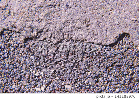 Weathered Concrete Surface With Coarse Gravel Texture and Eroded Cement Layers Under Natural Daylight 143188976