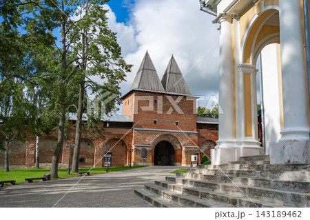 A tranquil scene of a historic fortress gate, featuring sturdy brick walls, pointed towers, and an arched walkway leading up to the entrance. The setting is serene and bathed in natural day. A tranquil scene of a historic fortress gate, featuring sturdy brick walls, pointed towers, and an arched walkway leading up to the entrance. The setting is serene and bathed in natural day. 143189462
