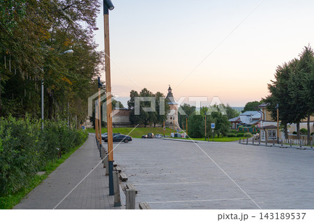 Historical tower stationary, in urban park, with historical tower, streetlights, cars, buildings, from a street level perspective, with green, gray accents, and serene mood, nearby objects. Historical tower stationary, in urban park, with historical tower, streetlights, cars, buildings, from a street level perspective, with green, gray accents, and serene mood, nearby objects. 143189537