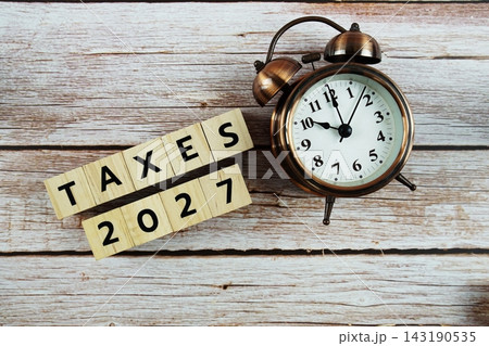 Taxes 2027 alphabet letter on wooden background Taxes 2027 alphabet letter on wooden background 143190535
