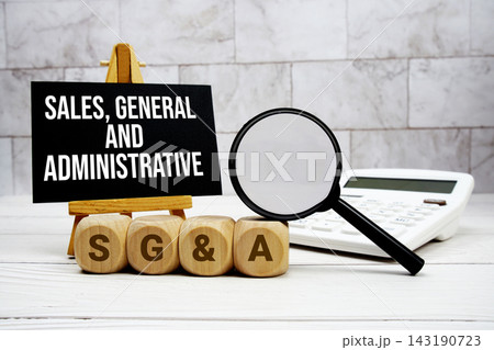 SG&A Sales, General, and Administrative text with calculator magnifying glass and on wooden background SG&A Sales, General, and Administrative text with calculator magnifying glass and on wooden background 143190723