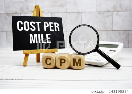 CPM Constant Payment Mortgage text with calculator magnifying glass and on wooden background 143190854