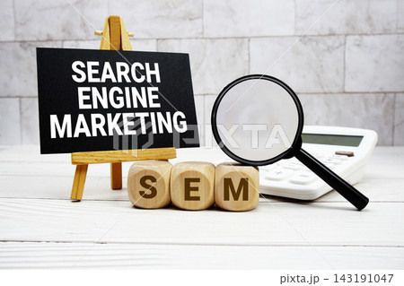 SEM Search Engine Marketing text with calculator magnifying glass and on wooden background SEM Search Engine Marketing text with calculator magnifying glass and on wooden background 143191047
