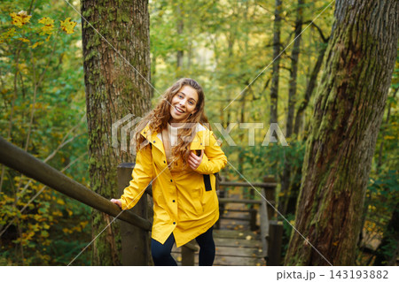 Portrait of young woman walking in the forest. Travelling, lifestyle, adventure. Portrait of young woman walking in the forest. Travelling, lifestyle, adventure. 143193882