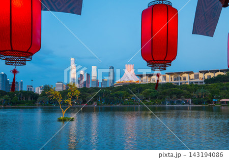 Lanterns hanging over lake with city skyline in background at tw Lanterns hanging over lake with city skyline in background at tw 143194086