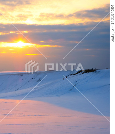 夕陽でオレンジ色に染まる雪景色 鳥取砂丘 夕陽でオレンジ色に染まる雪景色 鳥取砂丘 143194504