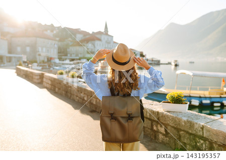 Young woman enjoying the views amazing landscape during vacation. Back view. Lifestyle, travel. Young woman enjoying the views amazing landscape during vacation. Back view. Lifestyle, travel. 143195357