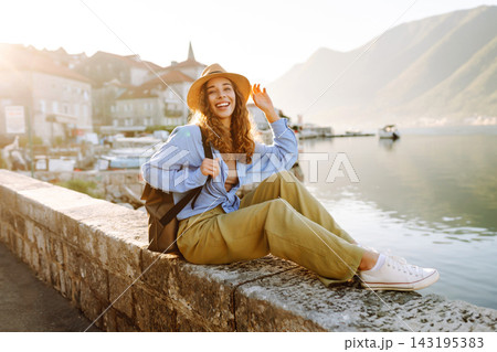 Young woman enjoying the views amazing landscape during vacation. Back view. Lifestyle, travel. 143195383