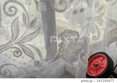 Sunlight passing through a lace curtain in a room near a window Sunlight passing through a lace curtain in a room near a window 143195677