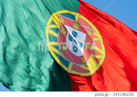 Extreme close up of the Portuguese coat of arms on a large waving national flag 143196228